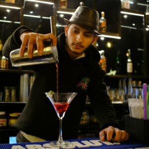 a person in a hat behind a bar